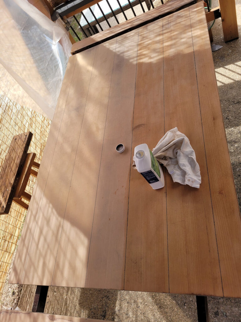 Raw wood table top in the process of being cleaned.
