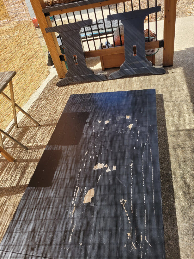 Large table sitting on the ground.